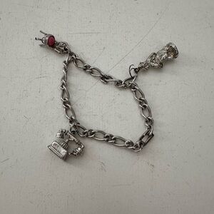 Vintage Avon charm bracelet with 3 charms telephone, pink chair and girl